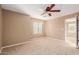 Spacious bedroom with ceiling fan and carpeted floor at 41705 N Globe Ct, Phoenix, AZ 85086