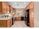 Well-equipped kitchen featuring wood cabinets and tile floors at 41705 N Globe Ct, Phoenix, AZ 85086