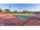 Well-lit tennis courts with green and red surfaces at 41705 N Globe Ct, Phoenix, AZ 85086