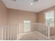 Upstairs hallway with white railing and carpeted flooring at 41705 N Globe Ct, Phoenix, AZ 85086