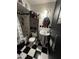 Bathroom with pedestal sink, black and white checkered floor, and shower at 4402 W Verde Ln, Phoenix, AZ 85031