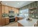 Modern kitchen features stainless steel appliances and wood cabinets at 4910 W Townley Ave # 4910, Glendale, AZ 85302