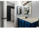 Bathroom with blue vanity and mirrored medicine cabinet at 5005 S Mill Ave, Tempe, AZ 85282