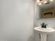 Simple bathroom with pedestal sink and updated fixtures at 5005 S Mill Ave, Tempe, AZ 85282