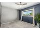 Bright bedroom with gray and blue walls, carpet, and ceiling fan at 5005 S Mill Ave, Tempe, AZ 85282