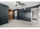 Spacious bedroom with grey walls, wood accent wall and ceiling fan at 5005 S Mill Ave, Tempe, AZ 85282