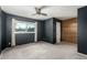 Spacious bedroom with grey walls, wood accent wall and ceiling fan at 5005 S Mill Ave, Tempe, AZ 85282