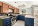 Updated kitchen boasts navy blue cabinets and stainless steel appliances at 5005 S Mill Ave, Tempe, AZ 85282