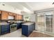 Updated kitchen boasts navy blue cabinets and stainless steel appliances at 5005 S Mill Ave, Tempe, AZ 85282