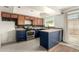 Updated kitchen boasts navy blue cabinets and stainless steel appliances at 5005 S Mill Ave, Tempe, AZ 85282