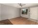 Living room featuring hardwood floors, large window, and ceiling fan at 5005 S Mill Ave, Tempe, AZ 85282