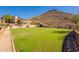 Large grassy backyard with walkways and a view of the main house at 5113 W Arrowhead Lakes Dr, Glendale, AZ 85308