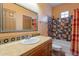 Bathroom with tiled tub and decorative accents at 5113 W Arrowhead Lakes Dr, Glendale, AZ 85308