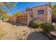 View of home's side elevation, landscaping, and brick wall at 5113 W Arrowhead Lakes Dr, Glendale, AZ 85308