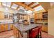 Large kitchen with granite island, wood cabinets, and exposed beams at 5113 W Arrowhead Lakes Dr, Glendale, AZ 85308