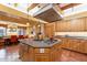 Spacious kitchen featuring granite countertops, an island, and ample wood cabinetry at 5113 W Arrowhead Lakes Dr, Glendale, AZ 85308