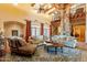 Living room with high ceilings, exposed beams, and a large brick fireplace at 5113 W Arrowhead Lakes Dr, Glendale, AZ 85308