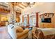 Two-story living room with high ceilings, exposed beams, and a large brick fireplace at 5113 W Arrowhead Lakes Dr, Glendale, AZ 85308