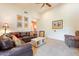 Living room with leather sofas and a ceiling fan at 5113 W Arrowhead Lakes Dr, Glendale, AZ 85308