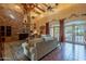 Spacious living room with high ceilings, exposed beams, and a brick fireplace at 5113 W Arrowhead Lakes Dr, Glendale, AZ 85308