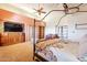 Main bedroom with large TV, built-in shelving, and comfy seating at 5113 W Arrowhead Lakes Dr, Glendale, AZ 85308