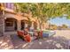 Relaxing patio with seating area and shade tree at 5113 W Arrowhead Lakes Dr, Glendale, AZ 85308