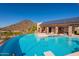 Stunning infinity pool with solar panels and mountain backdrop at 5113 W Arrowhead Lakes Dr, Glendale, AZ 85308