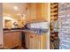 Wet bar with granite countertop, wood cabinetry, and wine rack at 5113 W Arrowhead Lakes Dr, Glendale, AZ 85308