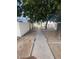 Shared walkway between condo units, shaded by large trees at 5233 N 42Nd Dr, Phoenix, AZ 85019