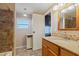 Bathroom features a vanity with granite countertop and tiled shower at 5402 E Mckellips Rd # 276, Mesa, AZ 85215