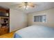 Bright bedroom with ceiling fan, hardwood floors and built-in shelving at 5402 E Mckellips Rd # 276, Mesa, AZ 85215