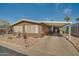 Tan manufactured home with carport, desert landscaping, and a small fountain at 5402 E Mckellips Rd # 276, Mesa, AZ 85215