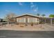 House exterior with landscaping, showcasing a desert-like setting at 5402 E Mckellips Rd # 276, Mesa, AZ 85215