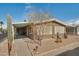 Front view of house with a covered patio and drought-tolerant landscaping at 5402 E Mckellips Rd # 276, Mesa, AZ 85215