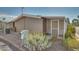 Side view of the house with a screened enclosure and landscaping at 5402 E Mckellips Rd # 276, Mesa, AZ 85215