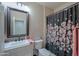 Clean bathroom with floral shower curtain and updated vanity at 5845 N Turquoise Ln, Eloy, AZ 85131