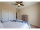 Spacious bedroom with double doors to closet and ceiling fan at 5845 N Turquoise Ln, Eloy, AZ 85131