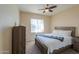 Cozy bedroom with wood-framed bed and ceiling fan at 5845 N Turquoise Ln, Eloy, AZ 85131