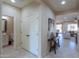 Hallway with powder room, coat closet, and view of living area at 5845 N Turquoise Ln, Eloy, AZ 85131