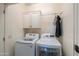 Convenient laundry room with washer, dryer, and overhead cabinets at 5845 N Turquoise Ln, Eloy, AZ 85131