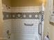 Modern bathroom with white subway tile, black and white geometric accents, and a sleek bathtub at 6124 N 130Th Ave, Litchfield Park, AZ 85340