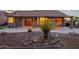 Home with covered patio, desert landscaping, and exterior lighting at 6403 S Fairway Dr, Gold Canyon, AZ 85118