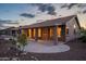 Home with covered patio, desert landscaping, and exterior lighting at 6403 S Fairway Dr, Gold Canyon, AZ 85118