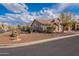 Home's exterior features desert landscaping and a two-car garage at 6403 S Fairway Dr, Gold Canyon, AZ 85118