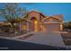 Evening view of a lovely one-story home with a welcoming front entrance at 6403 S Fairway Dr, Gold Canyon, AZ 85118