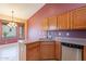 Kitchen with corner sink, wood cabinets, and stainless steel appliances at 6403 S Fairway Dr, Gold Canyon, AZ 85118