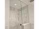 Spa-like shower with frameless glass enclosure and marble tile at 6587 N Palmeraie Blvd # 2010, Paradise Valley, AZ 85253