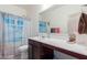 Clean bathroom, featuring a double vanity, shower and beach-themed curtain at 670 E Wiley Way, Casa Grande, AZ 85122