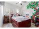 Charming bedroom with painted tree mural and a wooden bed frame at 670 E Wiley Way, Casa Grande, AZ 85122