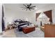 Cozy bedroom with ceiling fan, dresser, and a wooden storage chest at 670 E Wiley Way, Casa Grande, AZ 85122